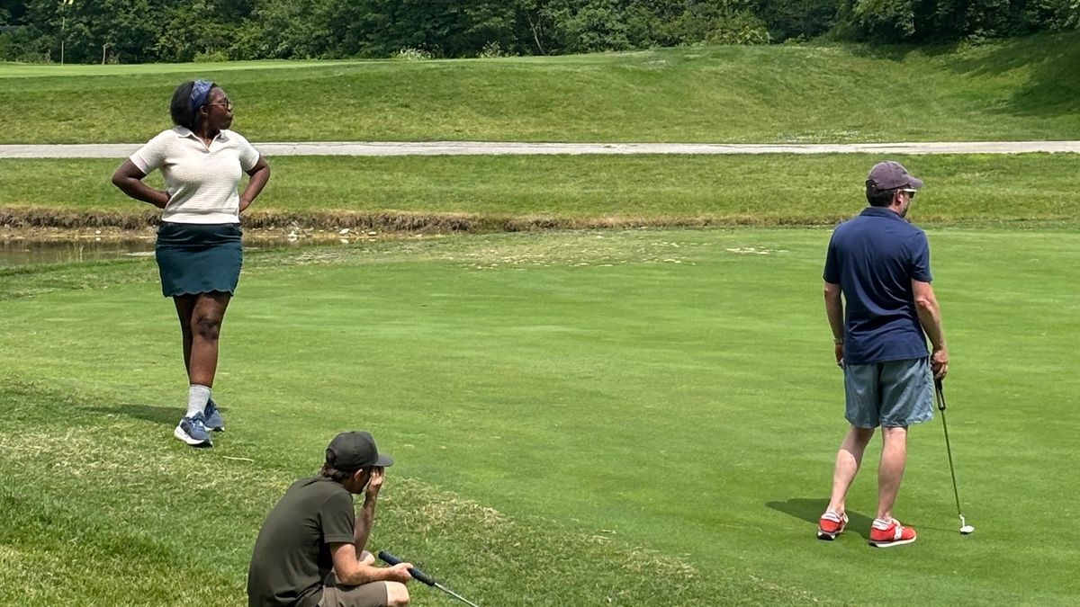 Sacha pretending she knows how to golf.