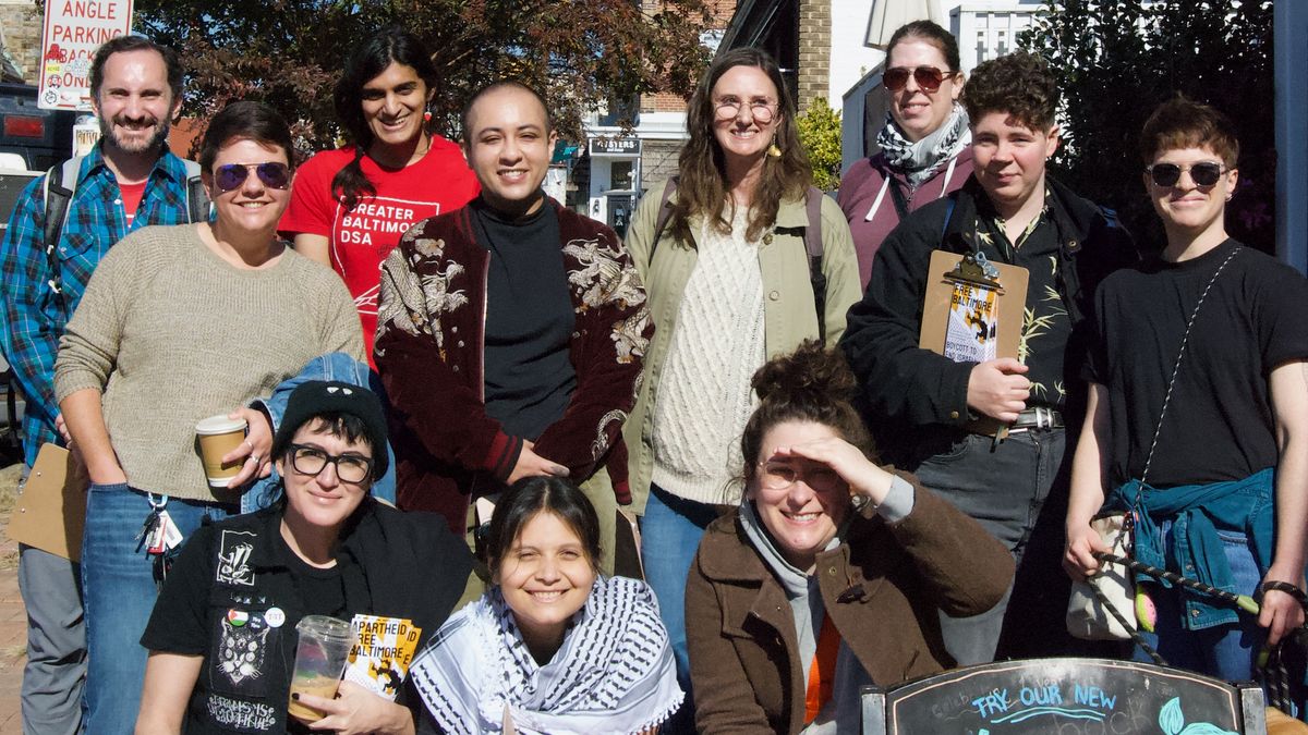 Group of 12 people outside holding canvassing materials for Apartheid-Free Baltimore.