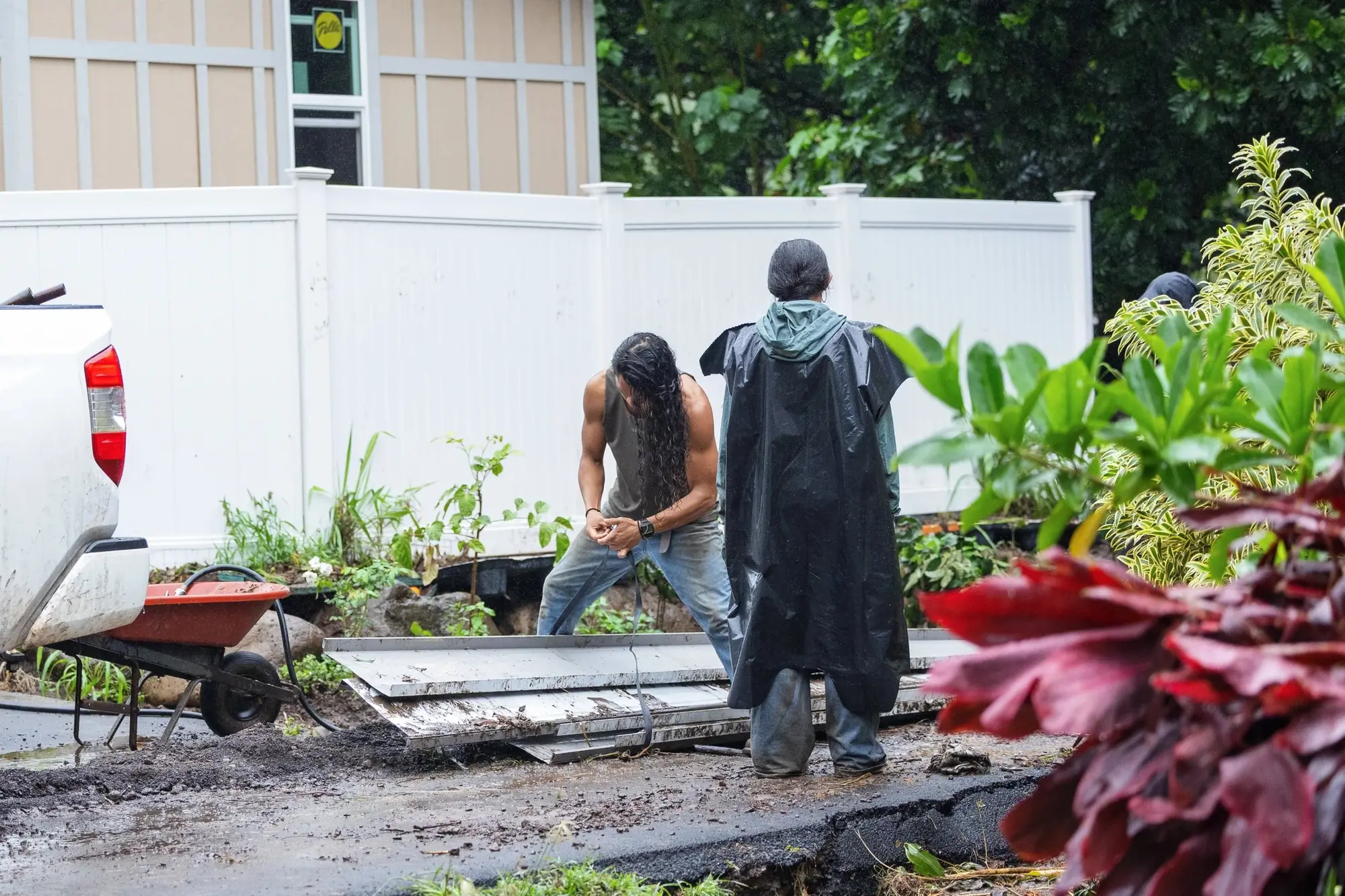 Neighbors cleaning up a home after the floods