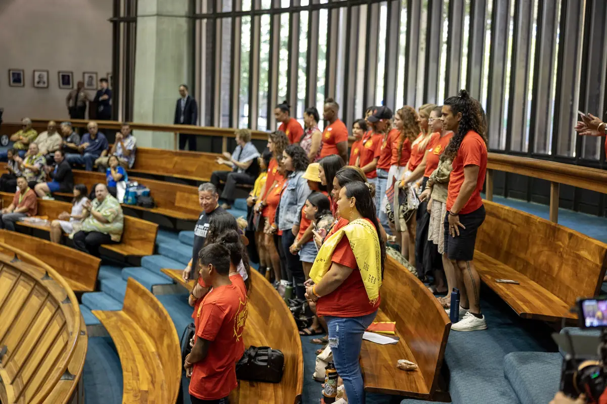 Community members in red shirts at the State Capitol