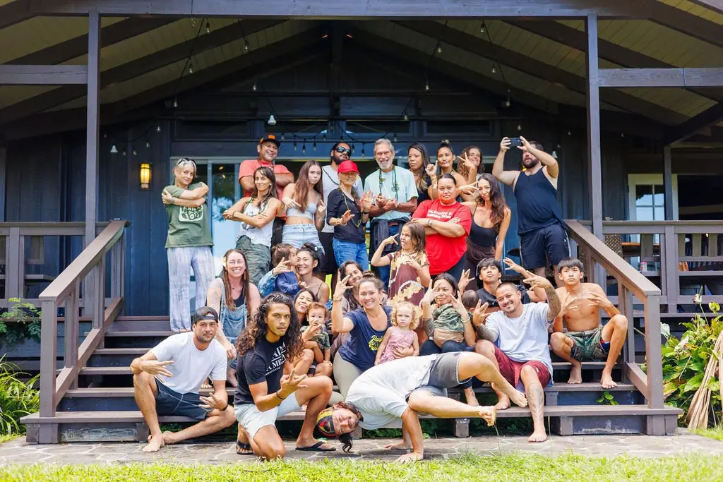 A large group of Lāhainā Strong volunteers posing on the steps of a community hall