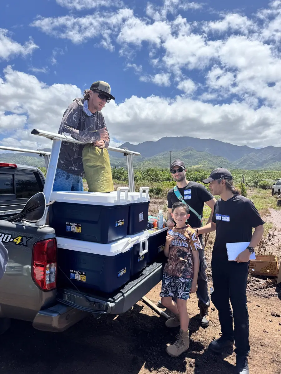 Neighbors gathered at a truck loaded with coolers on the Waiʻanae coast