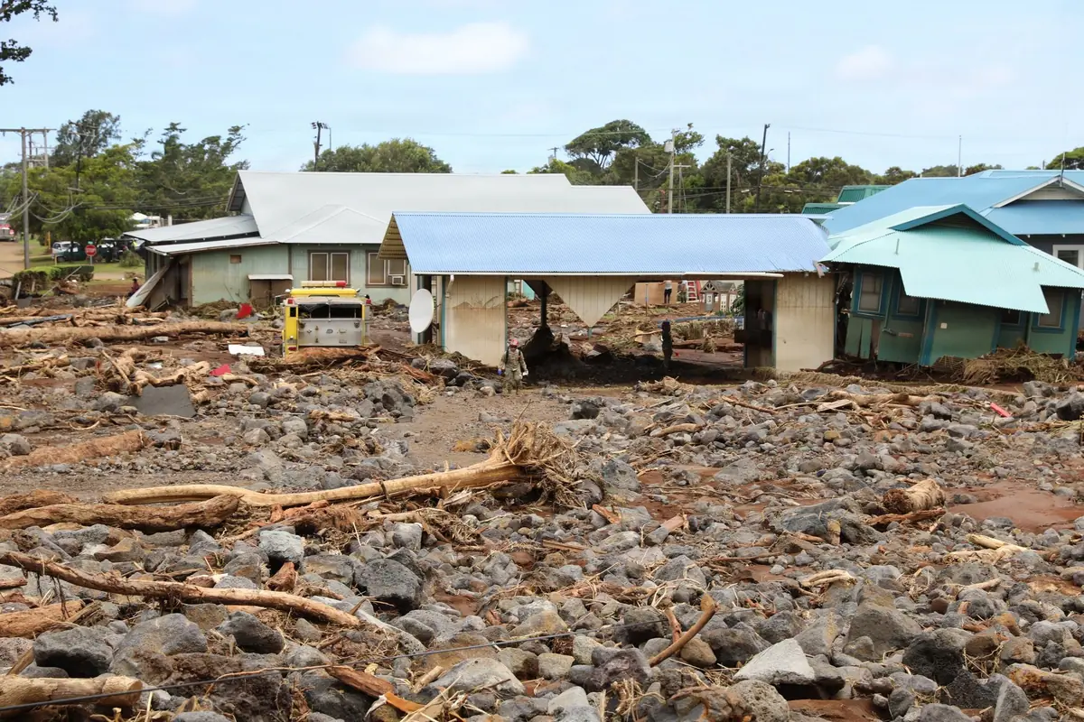 Homes surrounded by mud and debris after a storm